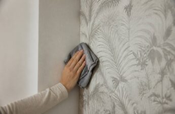Iemand maakt fotobehang schoon met een zachte microvezeldoek